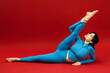 © wedmoments.stock - Woman practicing stretching exercises on red isolated background. Active lifestyle and fitness concept.