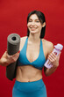 © wedmoments.stock - Female athlete holding a gym mat on red isolated background. Fitness, exercise and healthy lifestyle concept.