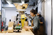 © Oleksii Syrotkin/Stocksy - Female worker packing package with coffee beans near male colleague