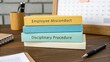 © Abu - Colorful Books on Desk Related to Employee Misconduct and Disciplinary Procedure in Office Setting