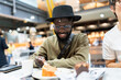 © Alvaro Lavin/Stocksy - Smiling man enjoying a sweet dessert and coffee at a cafe