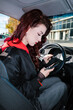 © Ezequiel Giménez/Stocksy - Woman texting on phone driving car
