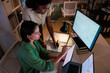 © Jovo Jovanovic/Stocksy - Two women analyze financial data on multiple screens.