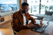 © Artcore Studio/Stocksy - Man uses laptop in stylish room