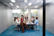 © Santi Nuñez/Stocksy - Diverse business team collaborating during conference room meeting
