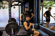 © Javier Díez/Stocksy - Two men workout in gym with weights and training equipment