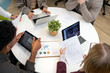 © Santi Nuñez/Stocksy - Business colleagues collaborating on data analysis during meeting