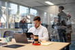© Santi Nuñez/Stocksy - Professional man working with digital tablet in modern office