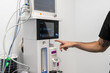 © Alvaro Lavin/Stocksy - Veterinarian using medical anesthesia machine in hospital