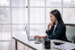 © Wasana - Businesswoman working at modern office desk