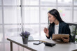 © Wasana - Businesswoman engaging in online meeting at office desk