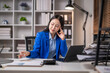 © Wasana - Focused businesswoman working in modern office