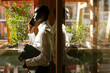© VICTOR TORRES/Stocksy - Businessman talking on phone in sunlit office