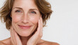 © AndiAzis - Smiling middle-aged woman with wavy light brown hair and clear skin, expressing happiness and confidence, against a plain white background