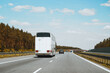 © AlexGo - White passenger bus driving through countryside