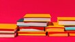 © Ryzhkov - Colorful stack of books on bright red background with copy space for education branding and bookstore advertising concepts in a minimalist modern studio setting