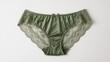 © Picstock - A beautiful pair of green silky lace women's underwear displayed on a white surface.