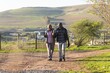 © Wavebreak Media - Senior african american couple with backpacks walking in sunny nature