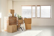 © Pixel-Shot - Wrapped furniture with stretch film and cardboard boxes in office on moving day