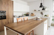 © Pixel-Shot - Interior of modern kitchen with counters, table and lamps