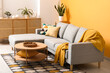 © Pixel-Shot - Interior of beautiful living room with cozy sofa, houseplants, cushions and coffee table