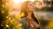 © dikifajarfadilah - young woman with closed eyes and hands over heart embracing a moment of peace and self-care in warm golden hour light outdoors.