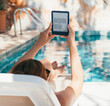 © Soloviova Liudmyla - Relaxed young woman enjoying sunny poolside leisure while reading electronic book on lounger. Summer vacation mood, peaceful atmosphere, digital reading lifestyle slow living modern relaxation concept