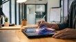© CreativeLoom - Close-up of person using a white stylus to interact with glowing digital wave charts on a tablet in a modern home office.