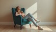 © Waqas - A serene woman relaxing in a comfortable teal armchair in a bright room with a peaceful atmosphere.