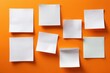 © Iryna - White sticky notes on vibrant orange background