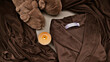 © shine.graphics - Cozy brown velvet robe, fuzzy slippers, and lit candle for ultimate relaxation and comfort