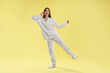 © New Africa - Beautiful woman in stylish pajamas posing on yellow background