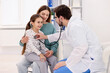 © New Africa - Little girl and her mother having appointment with pediatrician in hospital. Doctor checking child with stethoscope