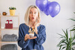 © Tatyana Gladskih - Portrait of happy middle aged woman holding birthday cake with lit candles