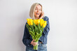 © Tatyana Gladskih - Happy adult woman hold bouquet of flowers at home