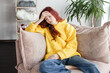 © Tatyana Gladskih - Upset thoughtful young woman sitting on couch