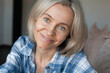 © Tatyana Gladskih - Close up portrait beautiful face happy middle age woman with blond hair looking at camera at home