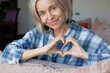 © Tatyana Gladskih - Woman showing hand heart gesture