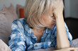 © Tatyana Gladskih - Upset and stress Middle age woman Sitting on Couch indoor