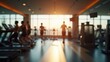 © rahwik - blurred busy gym interior with people exercising on cardio machines and weights sunlight streaming through large windows energetic fitness environment