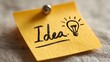 © tonifrito - Yellow sticky note featuring hand-drawn light bulb symbolizing an idea