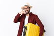 © luismolinero - Traveler man man with beard holding a suitcase over isolated white background making phone gesture. Call me back sign