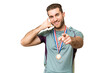 © luismolinero - Young handsome blonde man with medals over isolated chroma key background making phone gesture and pointing front