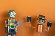 © besjunior - Happy smiling toy robot holding memory cards showing them to another robot with open laptop. Data transfer concept, digital collaboration poster