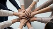 © Umi atih - Top view of diverse business people stacking hands together in a circle, symbol of teamwork, unity, and corporate partnership
