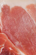 © nahhan - A detailed full frame shot of thin slices of dry cured prosciutto ham showing the marbled texture of meat and fat
