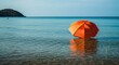 © Shahjahan - Vibrant orange umbrella on serene ocean waters