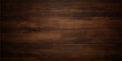 © jaduuu - A natural dark wood texture featuring an old brown timber grain pattern on a weathered oak plank surface