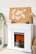 © Pixel-Shot - Pin board with old photos of relatives on fireplace in room. Family tree concept