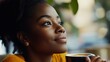 © vefimov - The image is of a young woman with a coffee cup in her hand, looking off to the side with a content expression. She appears to be enjoying her time indoors.